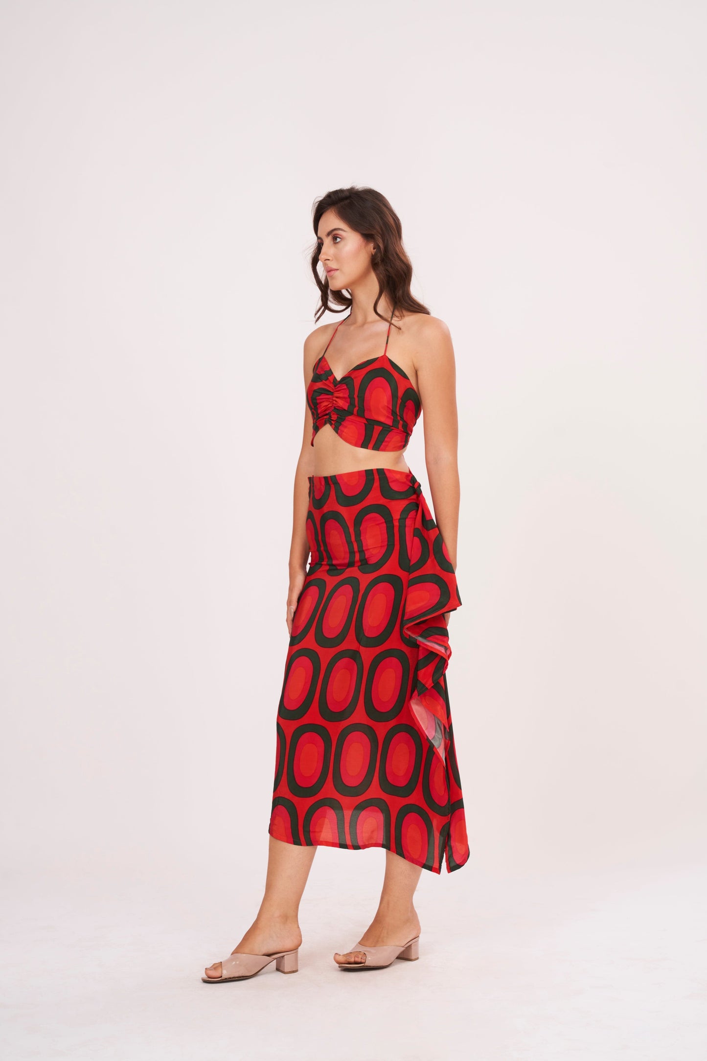 A stunning long skirt with a slit and cascading ruffles, offering a flirty and fun look while accentuating the silhouette, made from high-quality crepe.