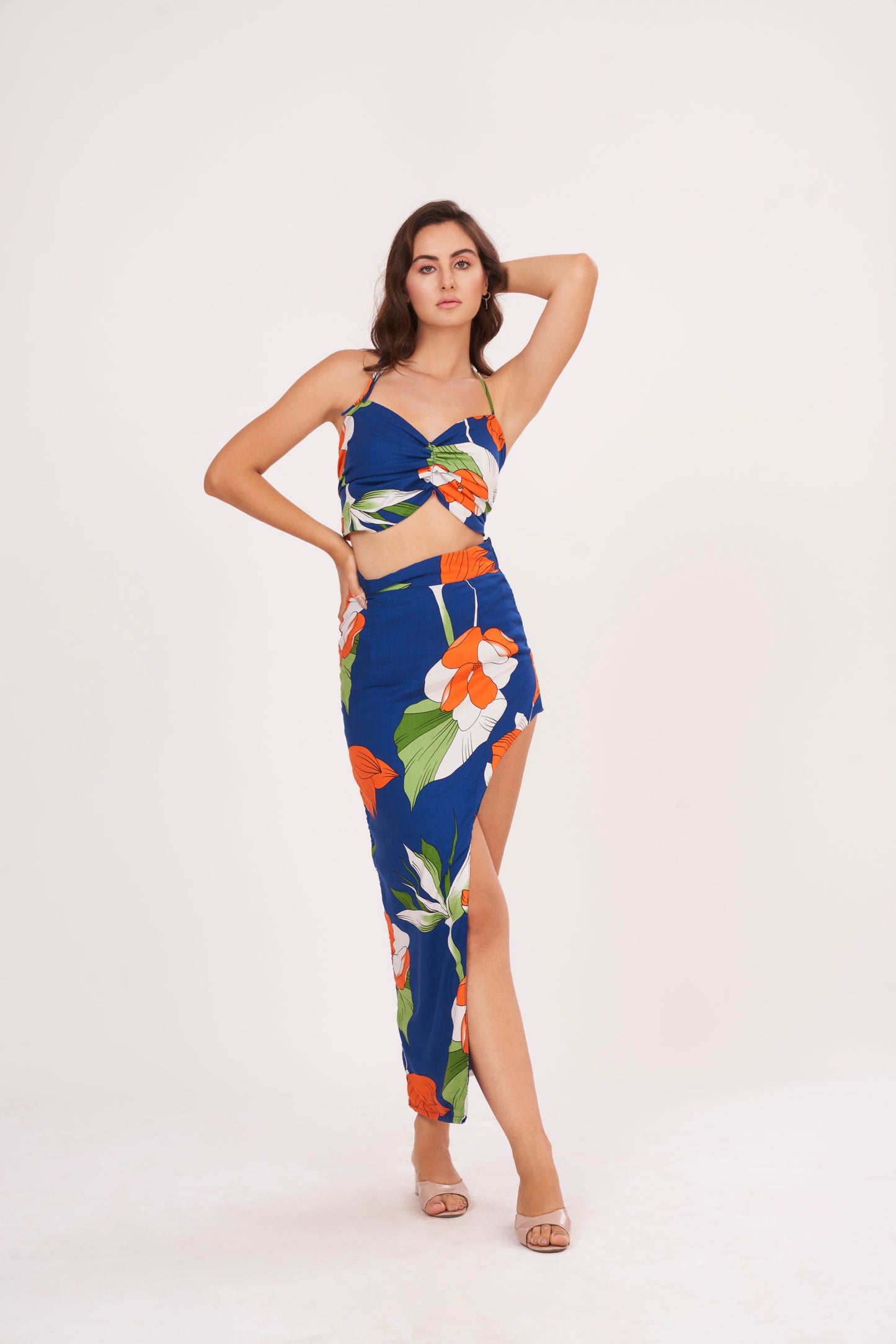 Designer crop top with intricate floral patterns in bold hues. Ruched gathering along bodice for snug fit. Made from high-quality muslin, perfect for any occasion.