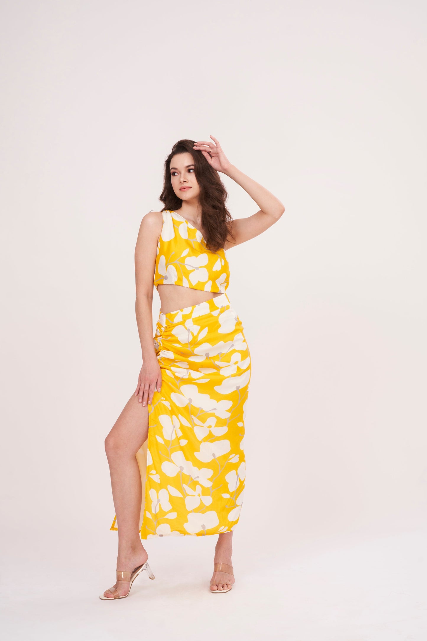 Stylish long skirt with vibrant yellow floral print, perfect for summer. Flattering waist cut creates stunning silhouette, while slit adds touch of elegance.