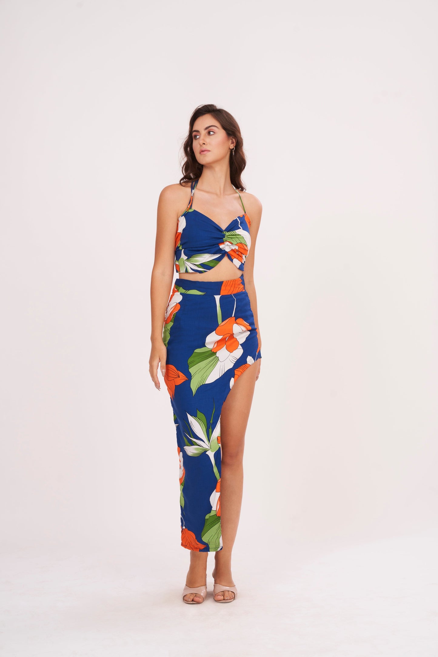 Designer crop top with intricate floral patterns in bold hues. Ruched gathering along bodice for snug fit. Made from high-quality muslin, perfect for any occasion.