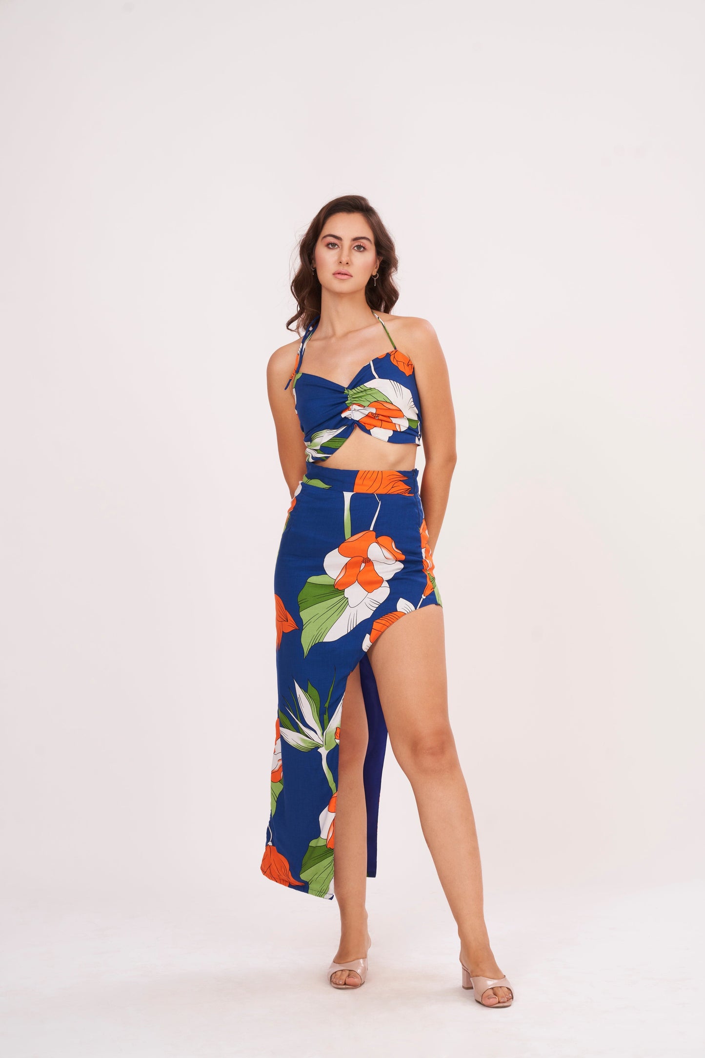 Designer crop top with intricate floral patterns in bold hues. Ruched gathering along bodice for snug fit. Made from high-quality muslin, perfect for any occasion.