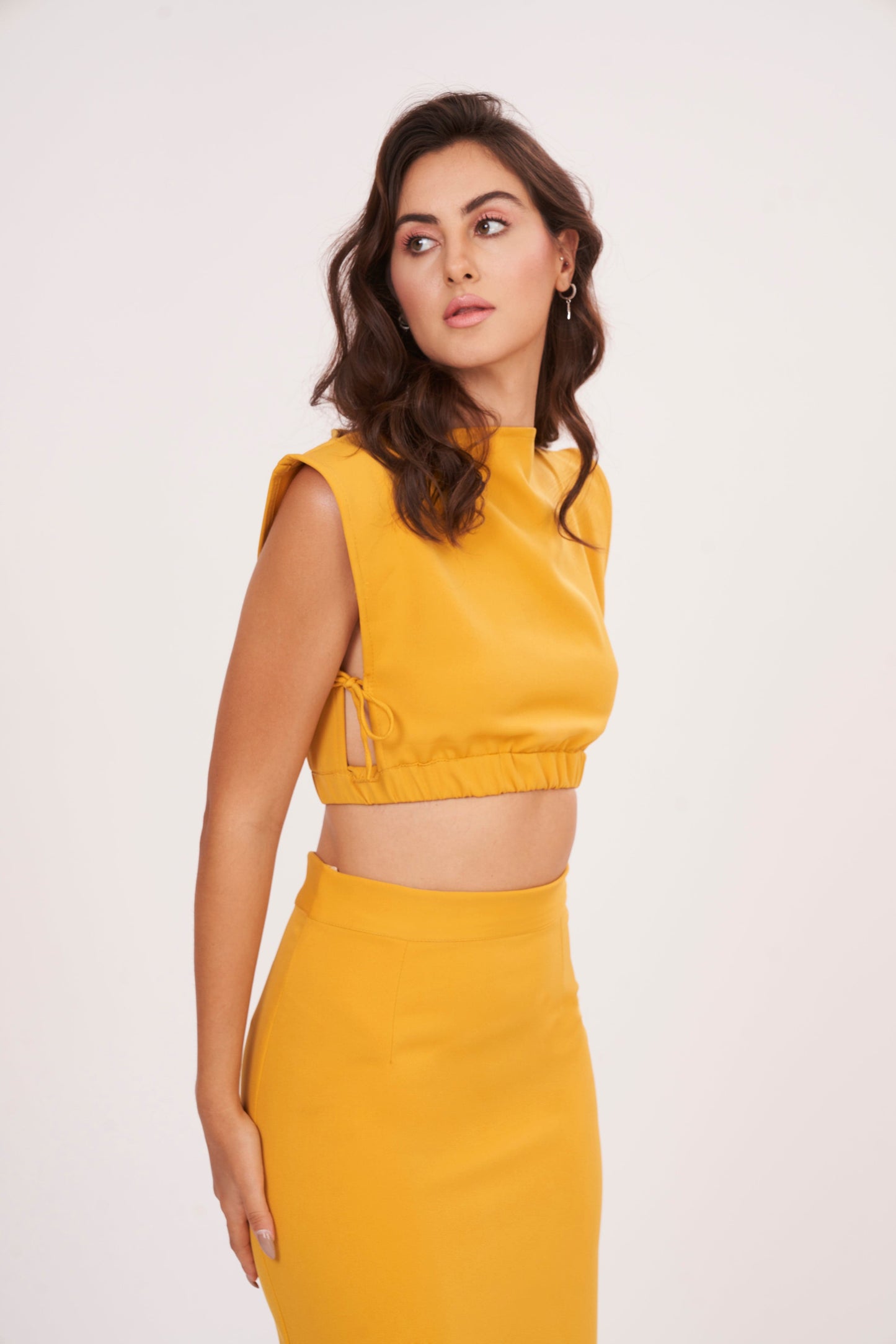 Mustard yellow square neck blouse made from high-quality muslin fabric. Clean and structured silhouette complements the ensemble.