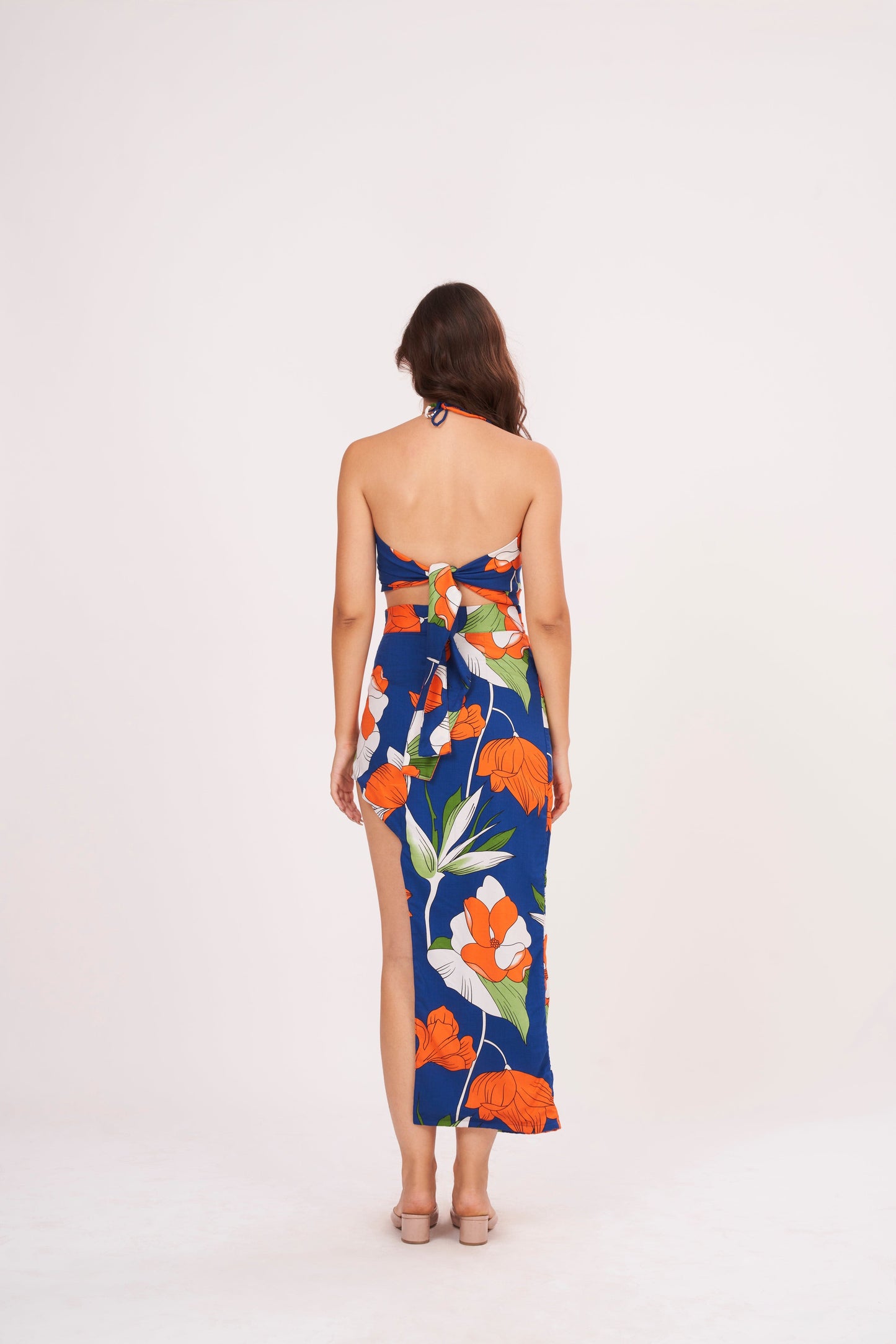 Designer crop top with intricate floral patterns in bold hues. Ruched gathering along bodice for snug fit. Made from high-quality muslin, perfect for any occasion.