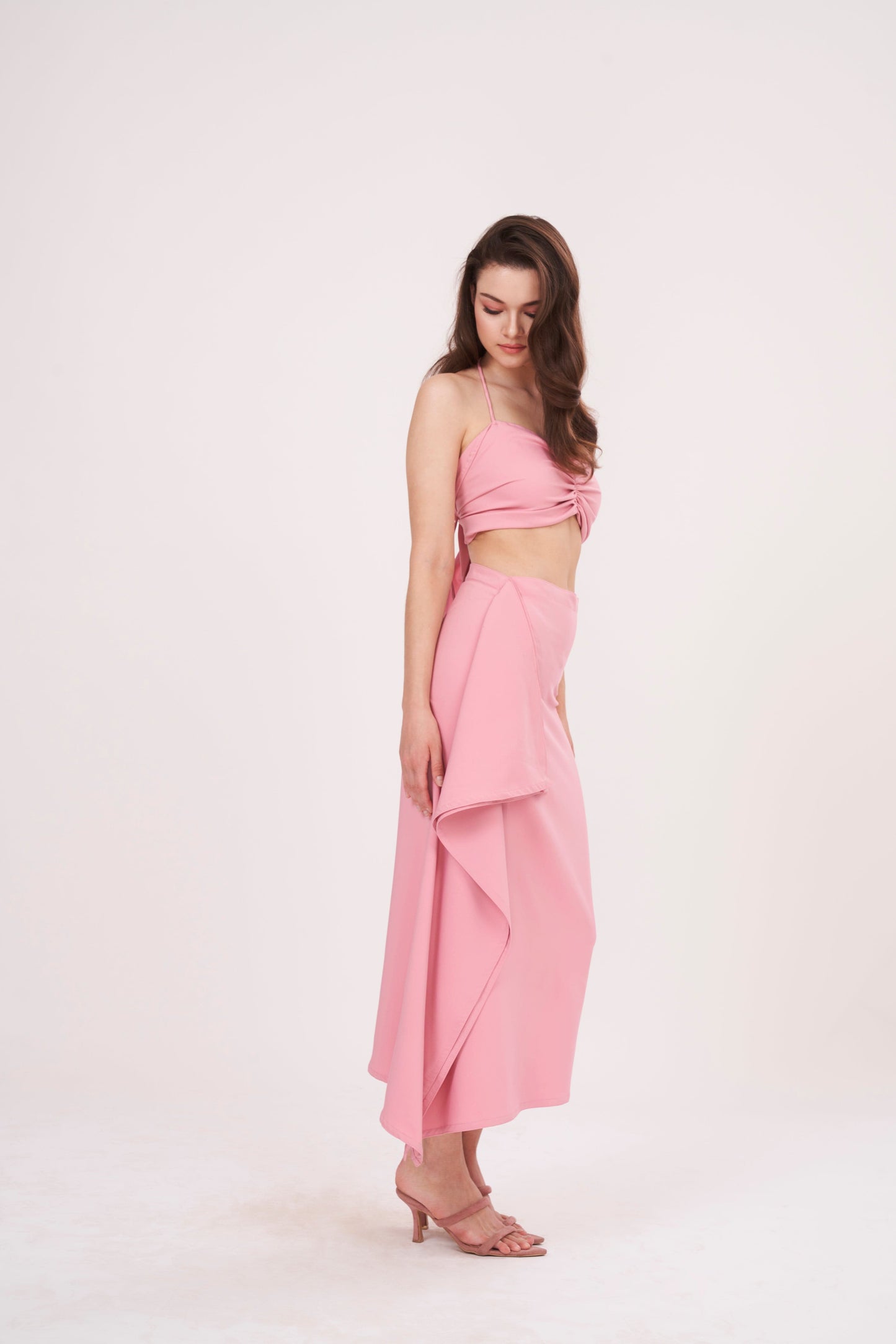 Tie-back crop top with ruched design and delicate pink hue. Ideal for any occasion. Can be paired with matching skirt or mixed and matched for a unique look.