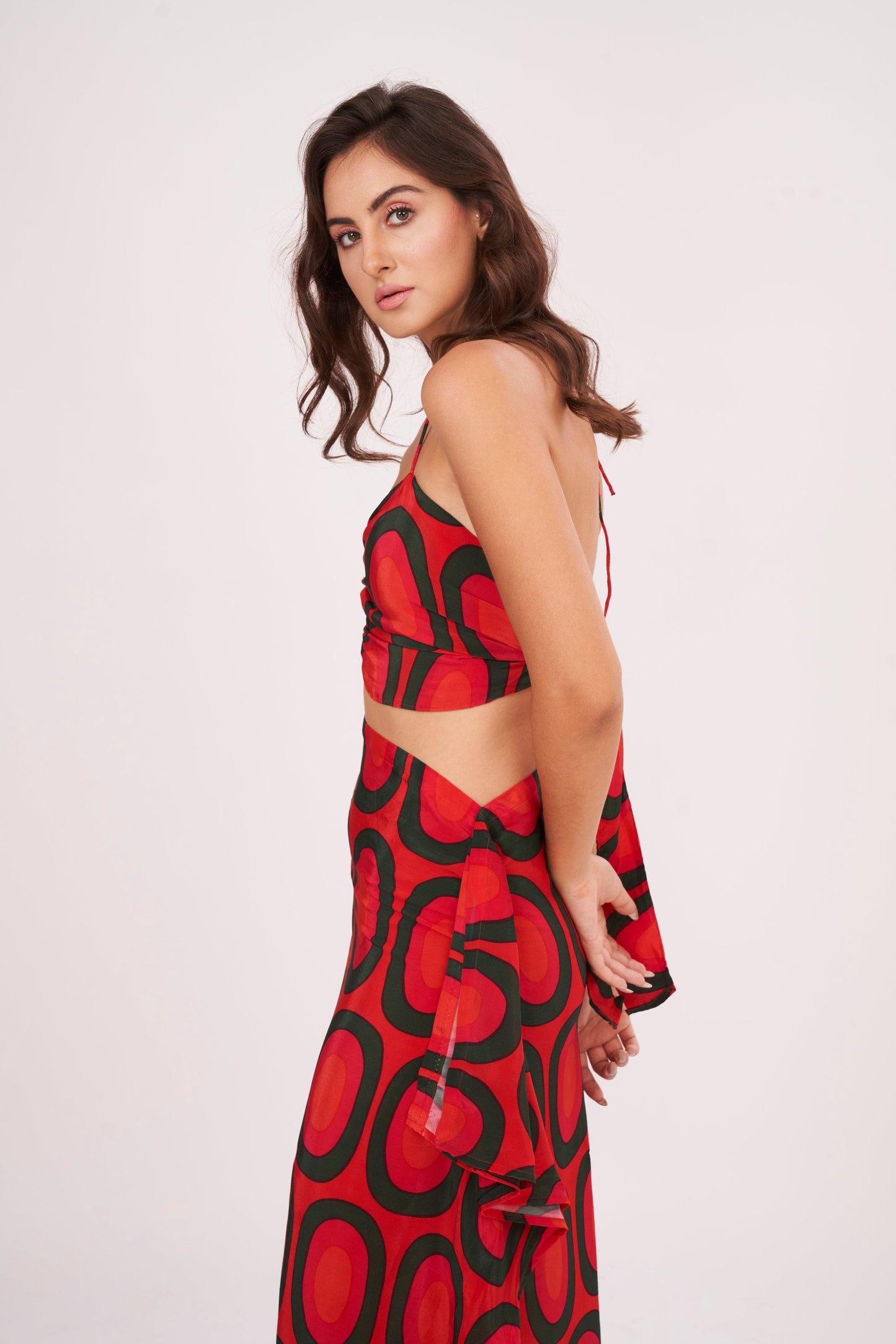 A stunning long skirt with a slit and cascading ruffles, offering a flirty and fun look while accentuating the silhouette, made from high-quality crepe.
