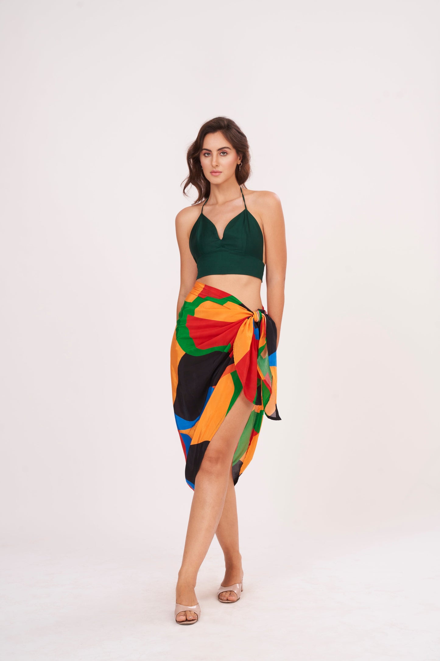 Elegant beach sarong wrap draping over a woman's curves, showcasing its versatile and timeless design, perfect for a beach vacation outfit.