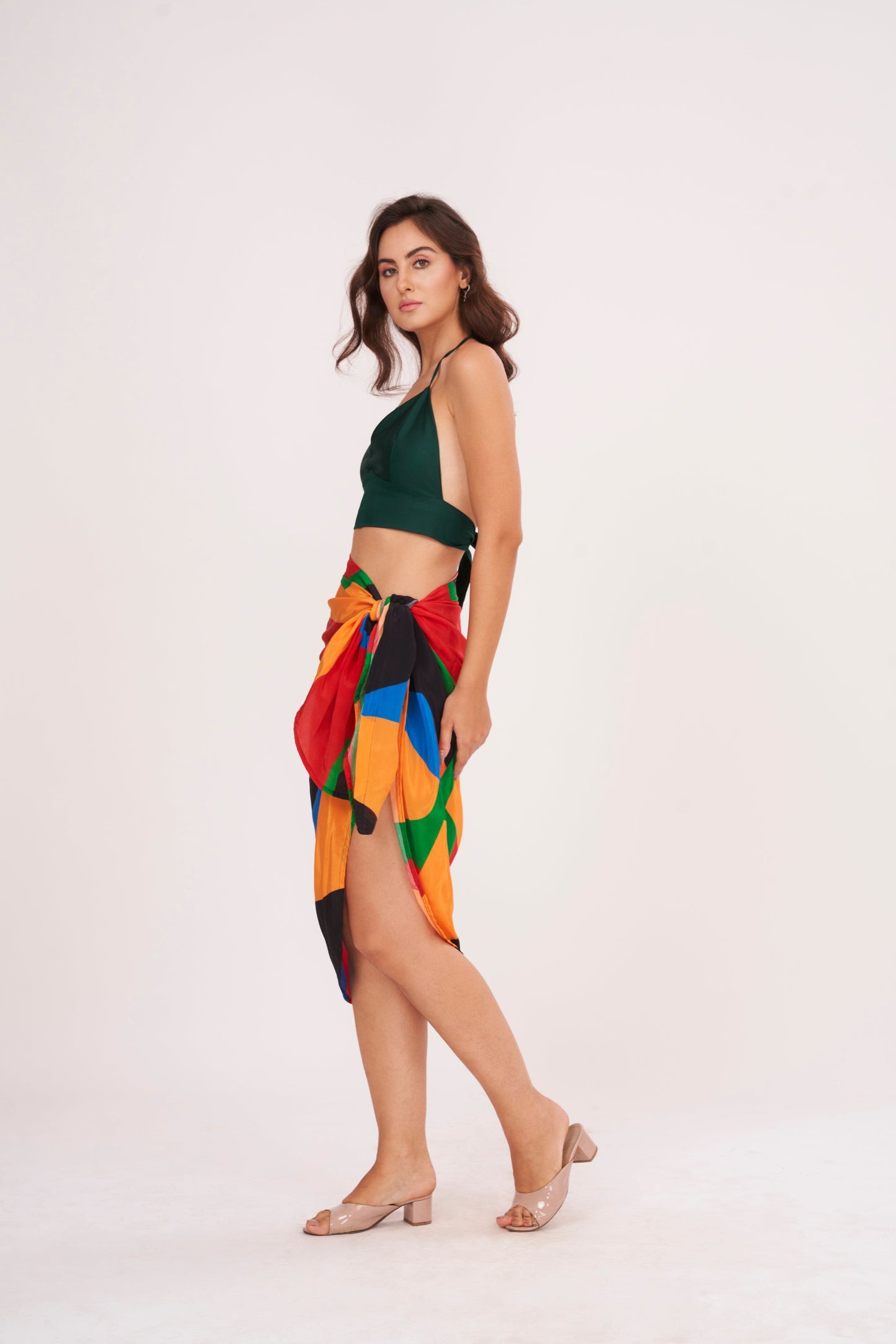 Elegant beach sarong wrap draping over a woman's curves, showcasing its versatile and timeless design, perfect for a beach vacation outfit.