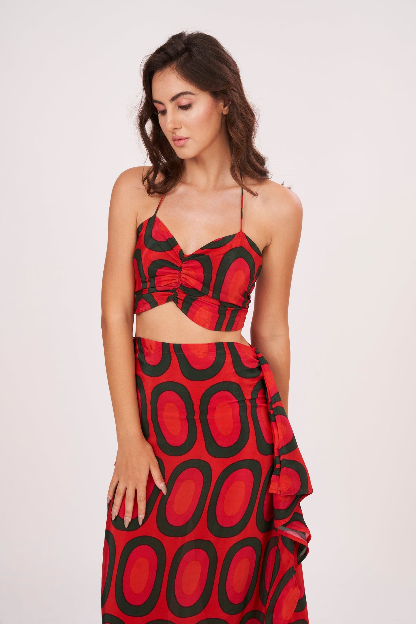 A stunning long skirt with a slit and cascading ruffles, offering a flirty and fun look while accentuating the silhouette, made from high-quality crepe.