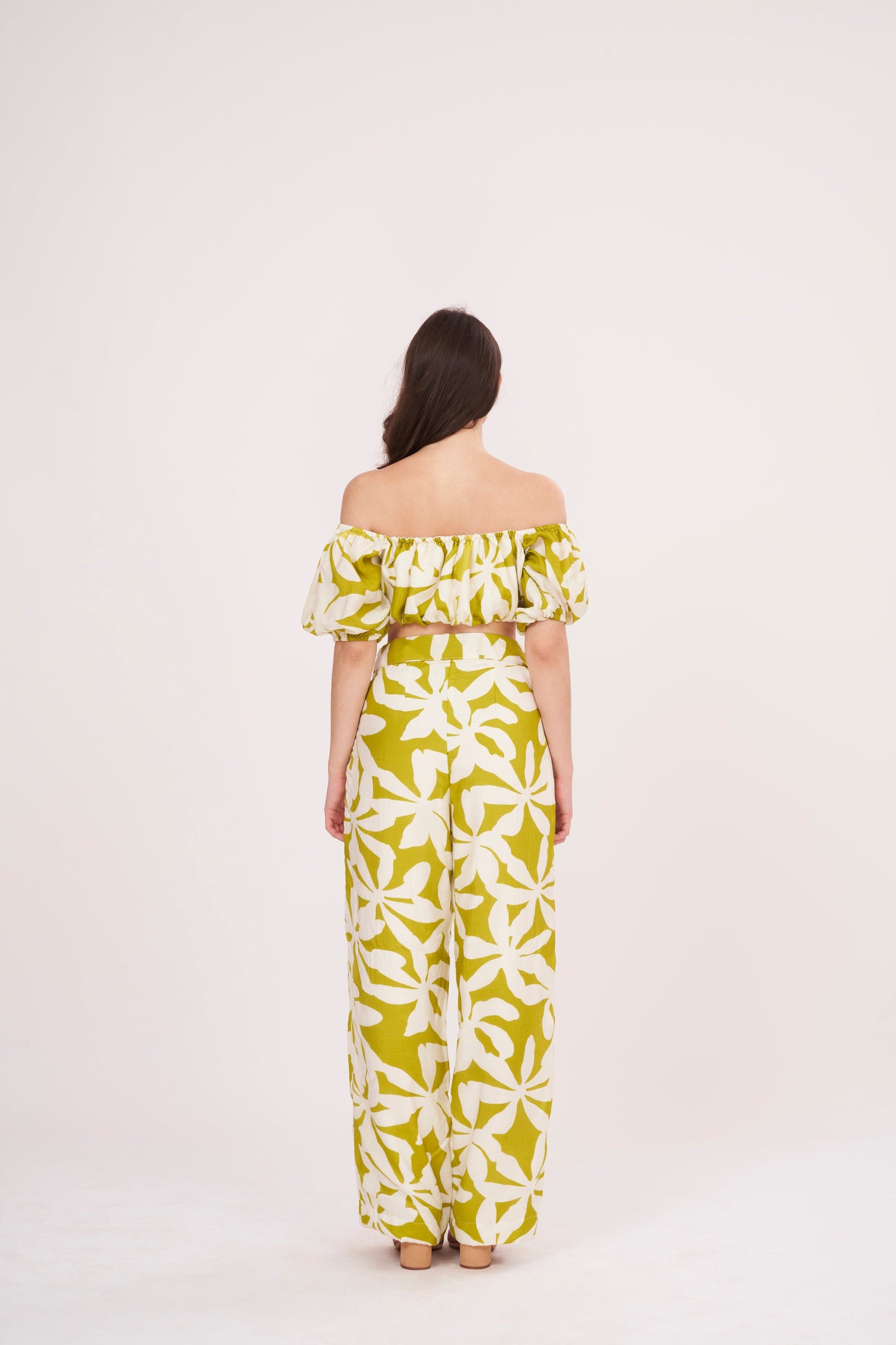 Elasticated-sleeve tube crop top with off-shoulder floral design, perfect for summer outings and casual evening dinners, featuring a green geometric print.