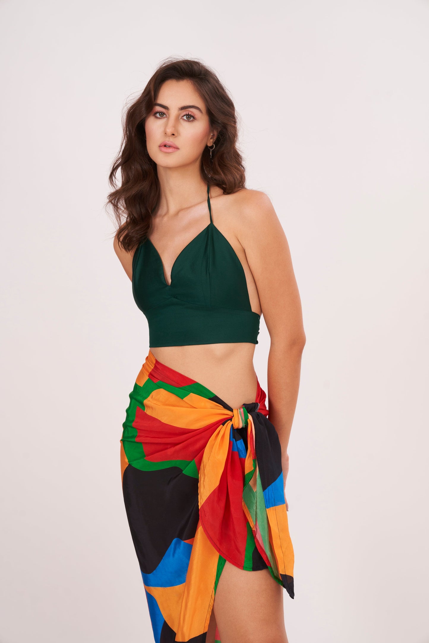 Elegant beach sarong wrap draping over a woman's curves, showcasing its versatile and timeless design, perfect for a beach vacation outfit.