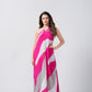 Model wearing a pink and white abstract print Chinnon halter dress, standing with one hand on the waist to highlight the relaxed, flowy silhouette.