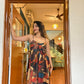 Bohemian maxi dress with thin straps and chest bow, chiffon fabric in bold multi-color abstract print by House of Varada