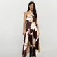 Two-piece bohemian wrap set featuring halter neckline crop top and flowy overlap skirt in earthy tones
