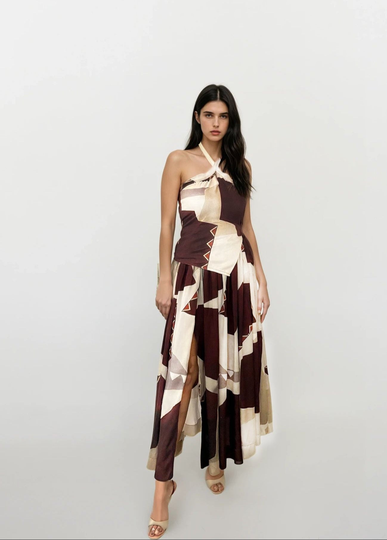 Two-piece bohemian wrap set featuring halter neckline crop top and flowy overlap skirt in earthy tones