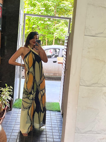 Full-length maxi dress crafted from a smooth, lightweight crepe fabric with a bold, artistic pattern and a clean, sleeveless finish perfect for tropical vacations.