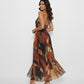Sleeveless halter maxi dress crafted from a lightweight Chinon blend, featuring a flowing A-line silhouette and an abstract print for an effortless bohemian look