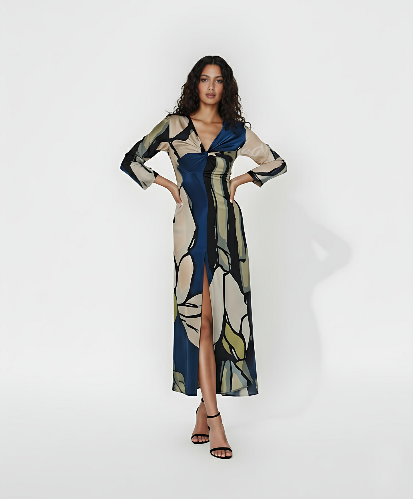 Full-length maxi dress featuring a high front slit and a sophisticated twist detail at the bodice. The design showcases an oversized abstract print in a palette of deep navy, sage green, and cream, making it a statement piece for semi-formal evening events.