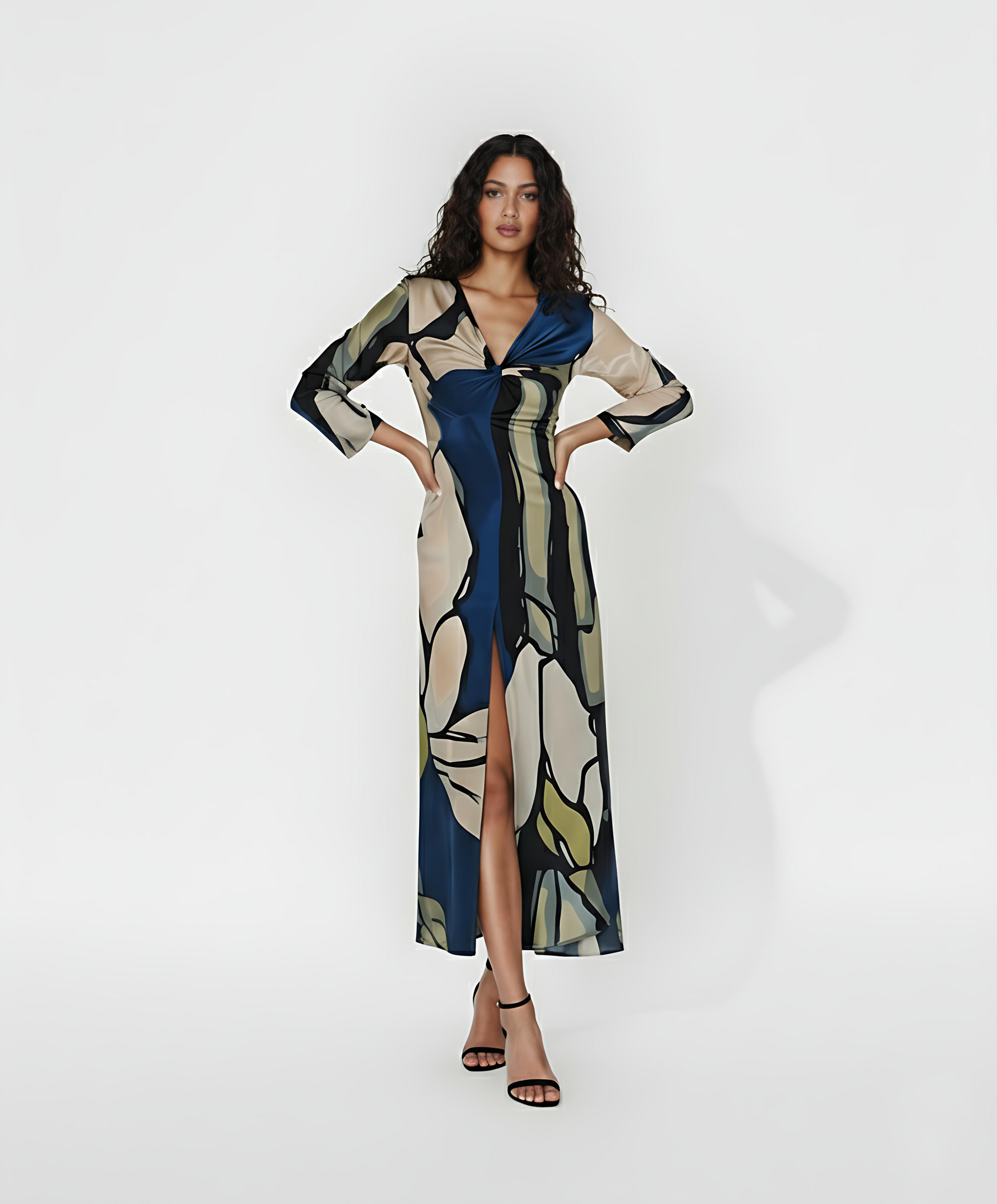 Full-length maxi dress featuring a high front slit and a sophisticated twist detail at the bodice. The design showcases an oversized abstract print in a palette of deep navy, sage green, and cream, making it a statement piece for semi-formal evening events.