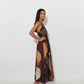 Sleeveless halter-neck midi dress featuring a multicolored abstract geometric print in deep maroon, earthy rust, and beige tones