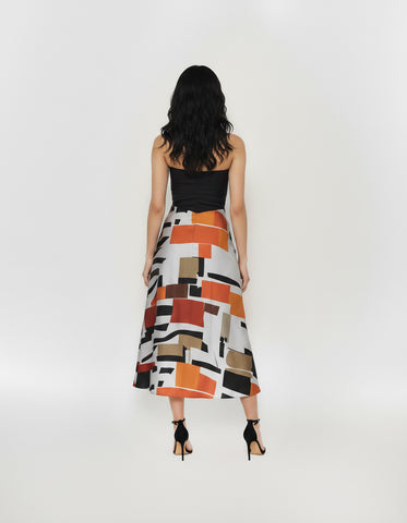 Back view of a sleeveless midi dress featuring a clean-lined black corset-style top and a flowing, multi-colored abstract print skirt.