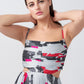 Close-up of the model in abstract floral dress, highlighting spaghetti straps and fitted bodice.