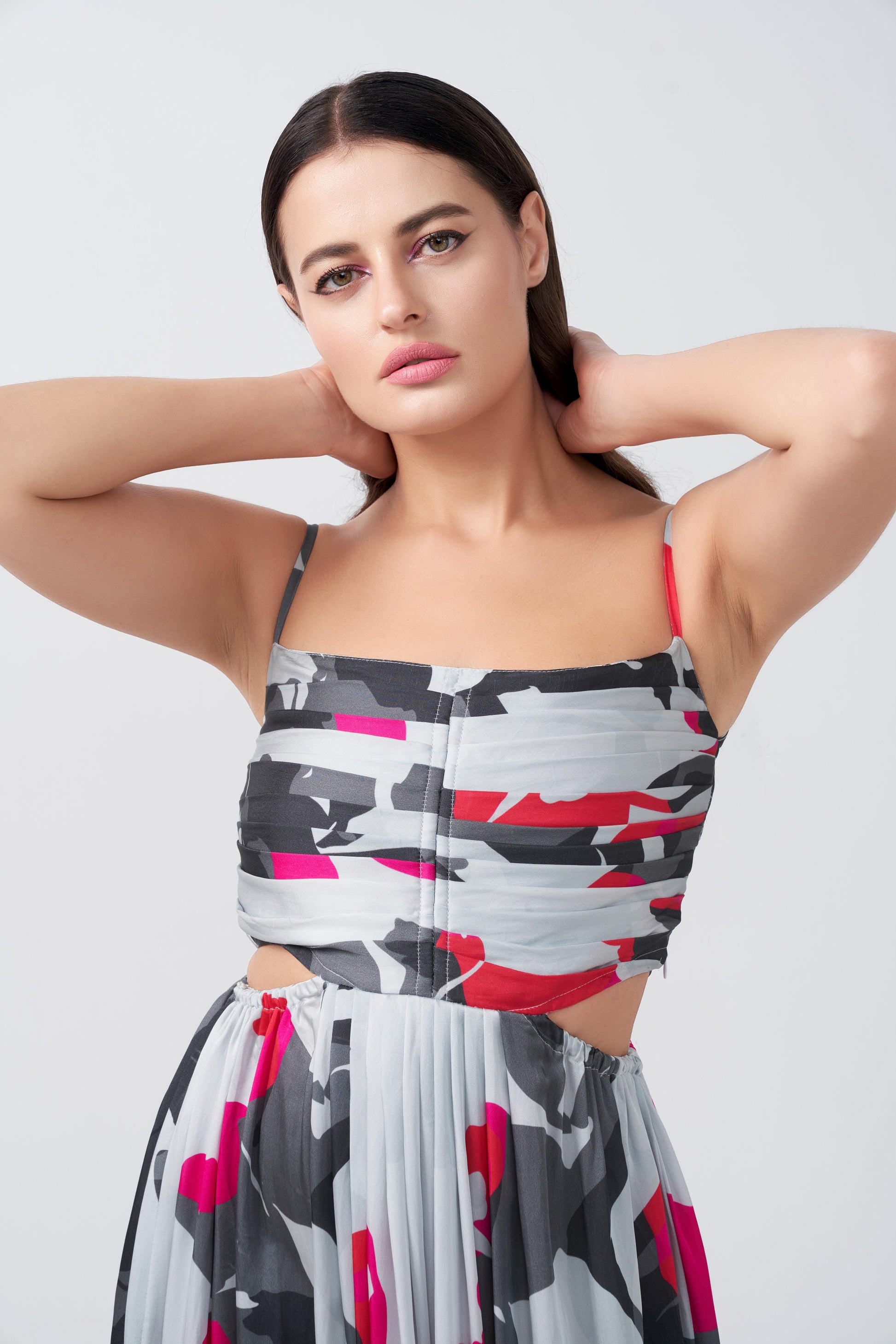 Close-up of the model in abstract floral dress, highlighting spaghetti straps and fitted bodice.