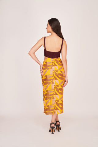 Rear view of the dress featuring back zip closure, maroon solid bodice, and multicolour abstract printed skirt.