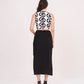 Rear view highlighting the halter neckline, zip closure, and minimalist back cut of the black skirt.