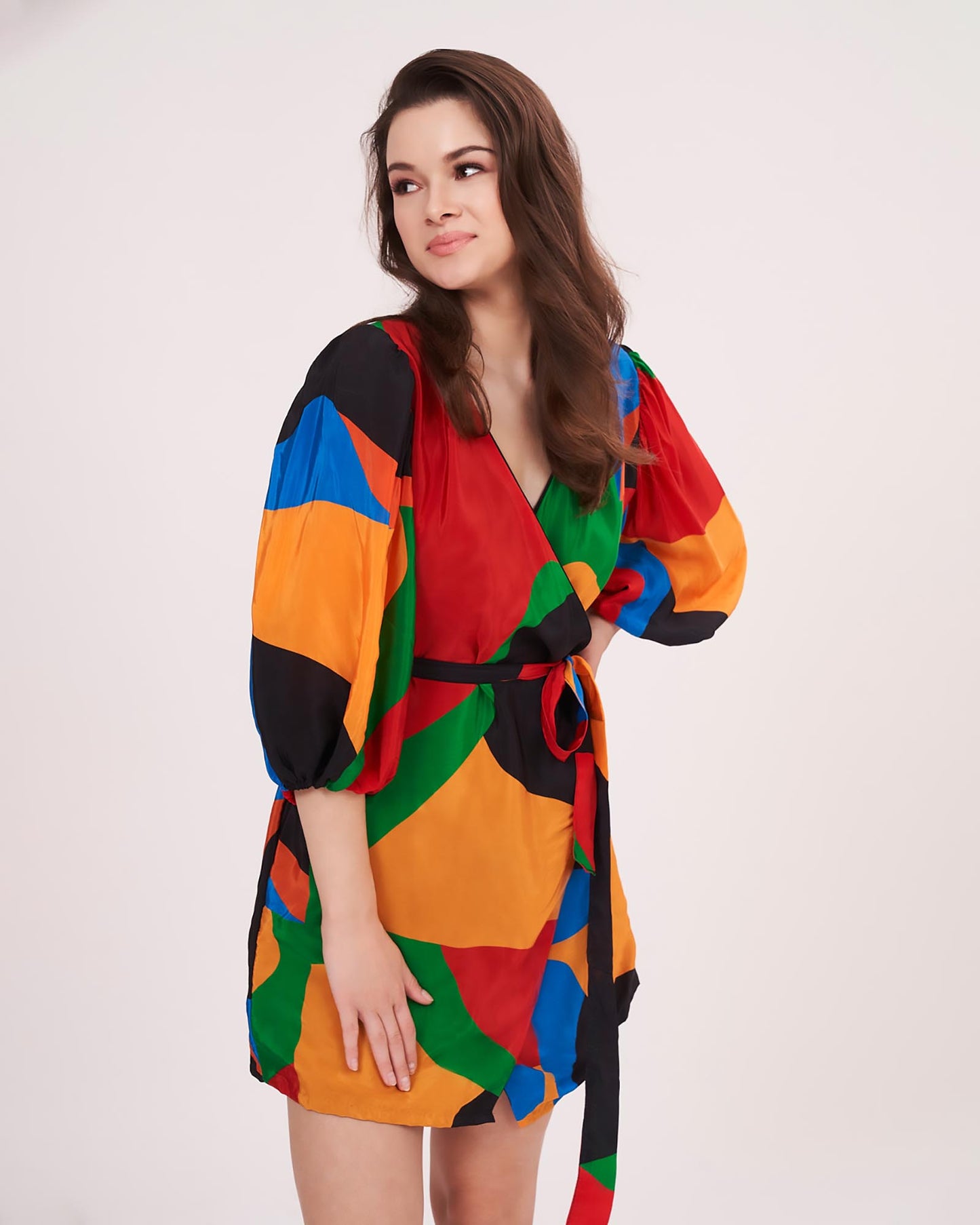 Close-up of the crossover V-neckline and waist tie detail, highlighting the smooth and colorful fabric.