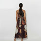 Back view of Sleeveless halter-neck midi dress with a gathered high neckline, tie waist, and abstract geometric print. 