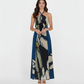 Sleeveless ankle-length crepe dress with an abstract floral print in navy, beige, and cream, featuring a flowing hem and elegant movement.