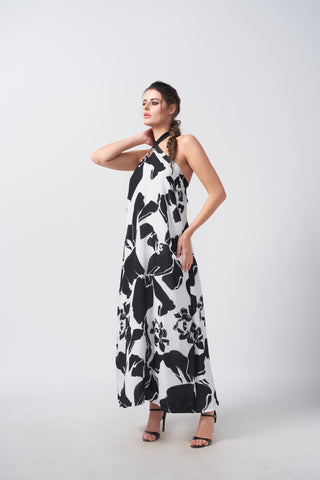 Halter-neck design with a distinctive crossover strap neckline and a relaxed, breezy silhouette that drapes loosely over the body.