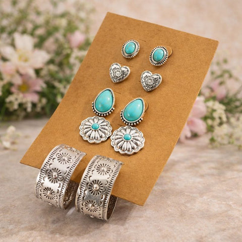 Set of antique silver and turquoise bohemian earrings including teardrop studs, flower dangles, heart studs, and embossed wide hoop earrings.
