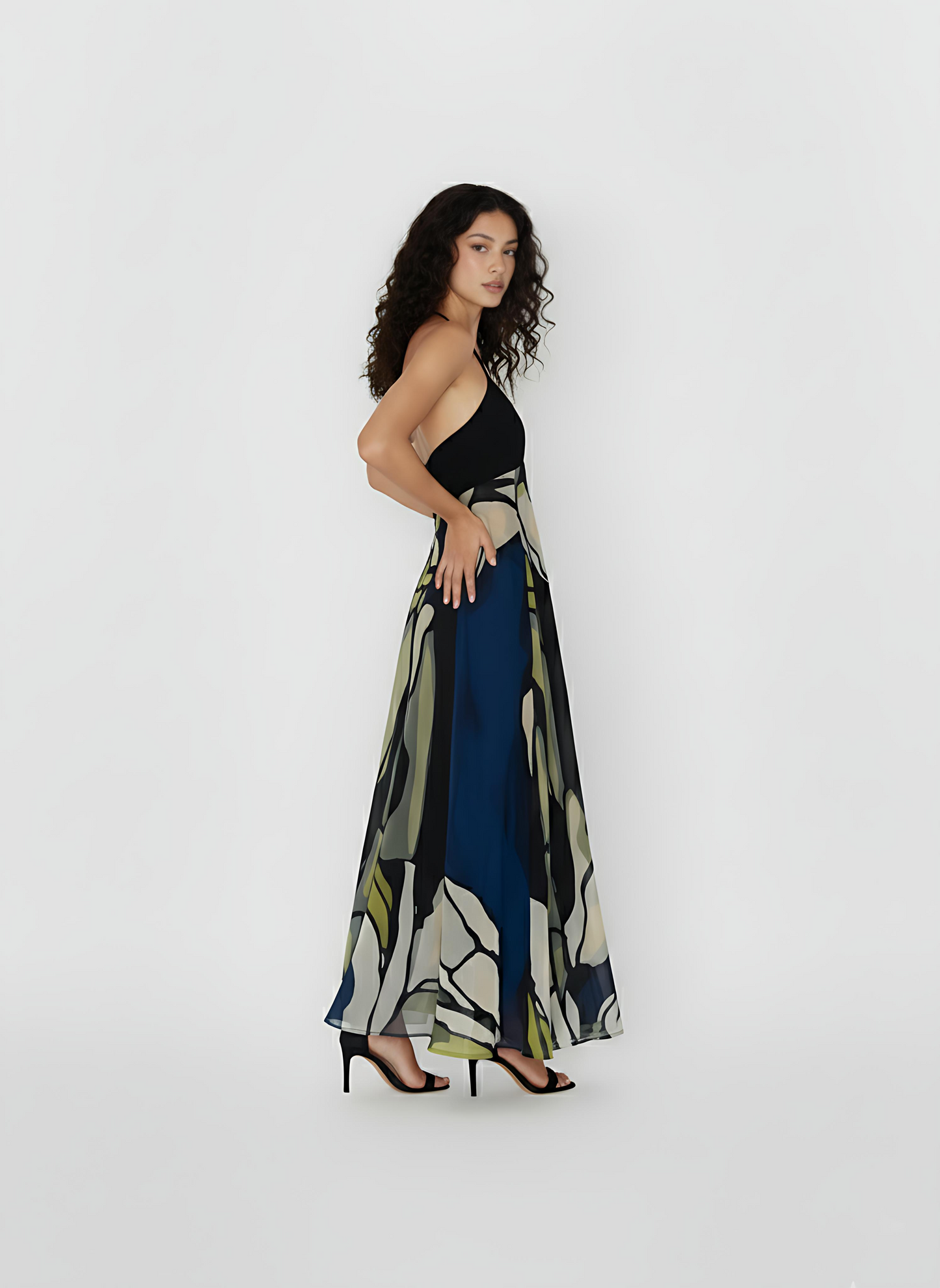 Sleeveless maxi dress emphasizing the intricate detail of its "Olive Dusk" print, which features organic shapes and soft, blurred outlines. The dress is crafted from a high-quality, breathable crepe fabric designed to offer comfort and movement for high-end summer celebrations.