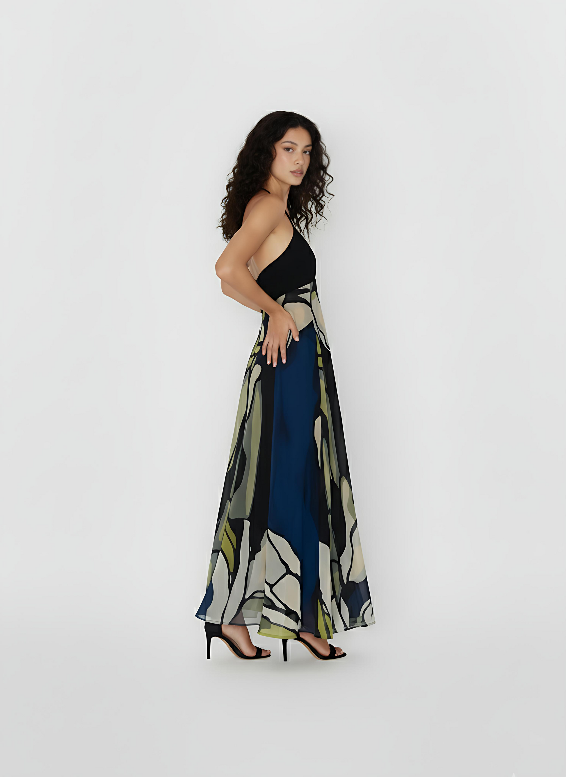 Sleeveless maxi dress emphasizing the intricate detail of its "Olive Dusk" print, which features organic shapes and soft, blurred outlines. The dress is crafted from a high-quality, breathable crepe fabric designed to offer comfort and movement for high-end summer celebrations.