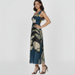 Ankle-length gown with a tailored side fit that highlights the smooth, flowing drape of the fabric in crepe. The large-scale botanical pattern continues seamlessly around the body, offering a sophisticated look for garden parties or elevated resort wear.