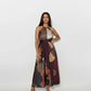 Sleeveless halter-neck midi dress with a gathered high neckline, tie-waist detail, and abstract geometric print