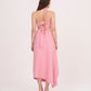 Rear view showing tie-up detail on the halter top and a clean back fall of the ruched ruffle skirt.