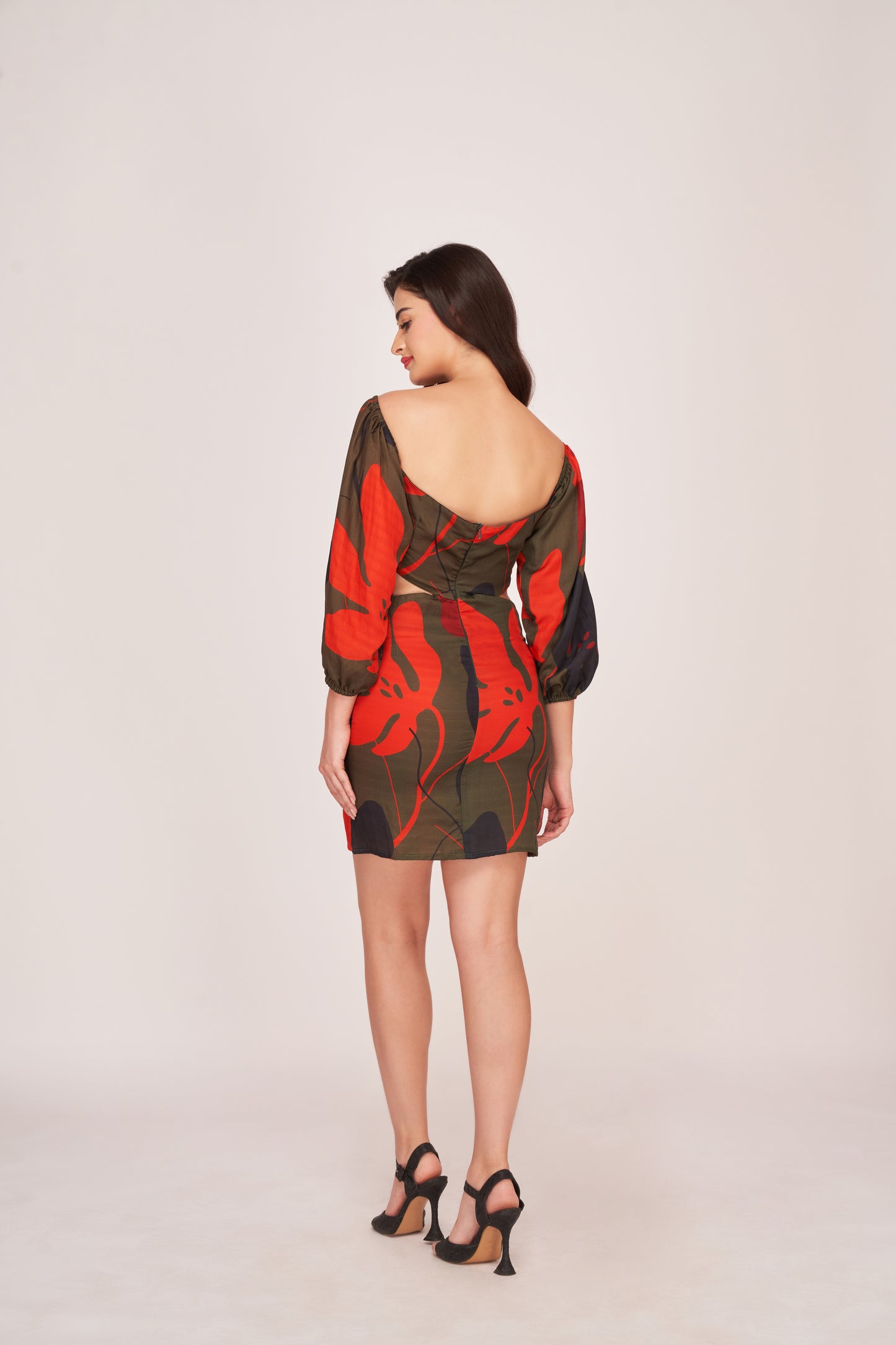 Rear view of the satin floral mini dress showing puffed sleeves, off-shoulder design, and back zip closure.
