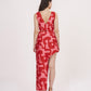 Rear view of the red printed co-ord set showcasing the open-back crop top and the skirt’s elegant flow.
