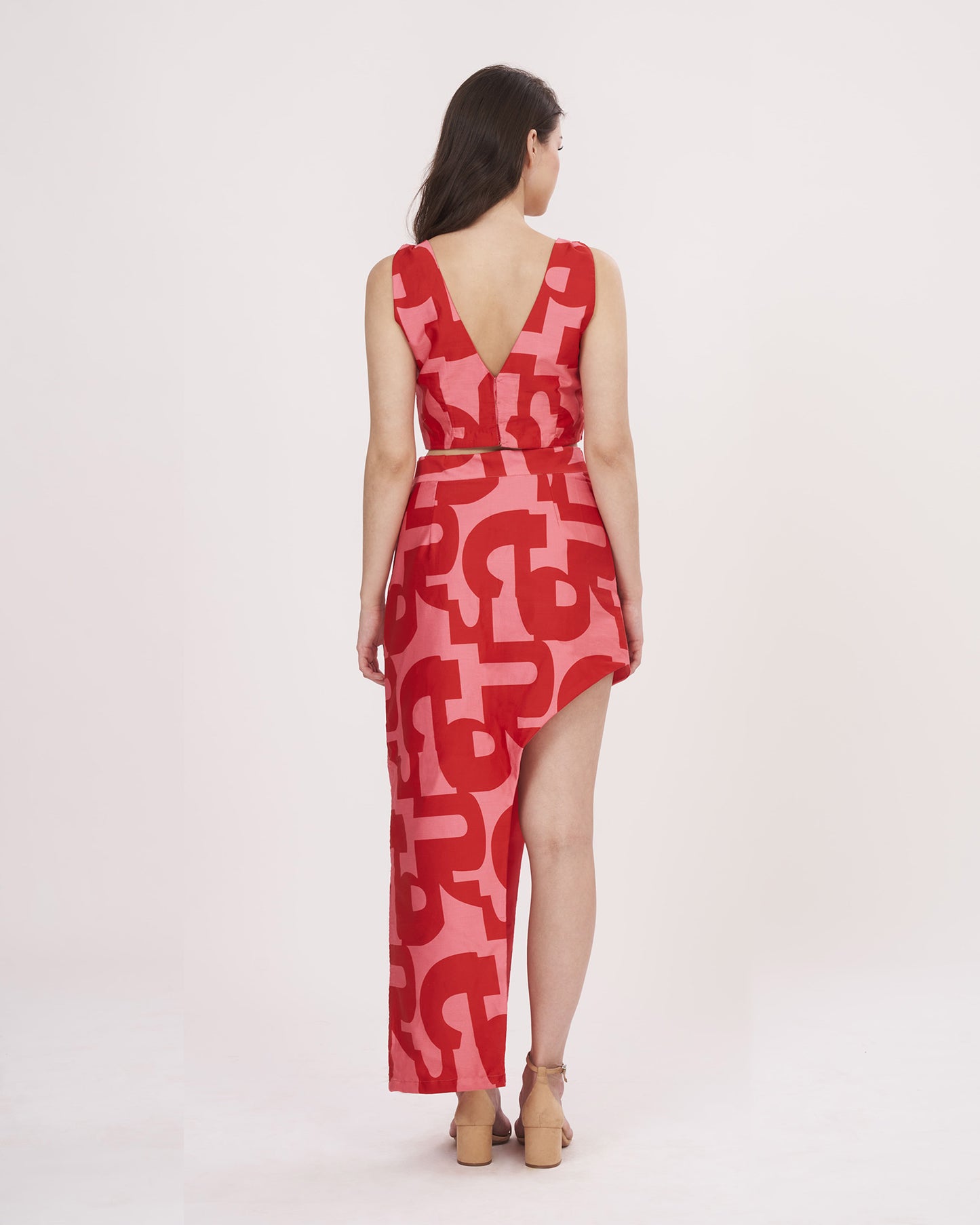 Rear view of the red printed co-ord set showcasing the open-back crop top and the skirt’s elegant flow.