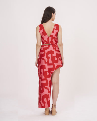 Rear view of the red printed co-ord set showcasing the open-back crop top and the skirt’s elegant flow.