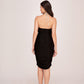 Rear view of the satin black and silver dress highlighting back zip closure and body-hugging fit.
