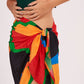 Multicolor beach sarong wrap featuring a bold geometric print in vibrant shades of orange, red, green, and black.