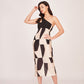 Model posing confidently in a black and white abstract print one-shoulder silk midi dress against a plain backdrop.