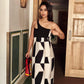 Model walking indoors in the one-shoulder abstract print midi dress, showcasing the dress’s flow in a lifestyle setting.