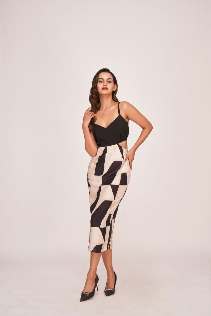 Model wearing a black abstract printed sleeveless satin midi dress with V-neckline and side cut-outs, posing front-facing.