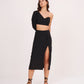 Full frontal pose showing the sweetheart neckline and dramatic balloon sleeve paired with a high-waist solid skirt.