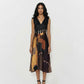 Sleeveless midi dress featuring a deep V-neckline and a solid black bodice that transitions into a multi-colored geometric mosaic print skirt.