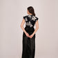 Rear back view of the floral co-ord set, revealing skirt drape and crop top fit from behind with an elegant posture.